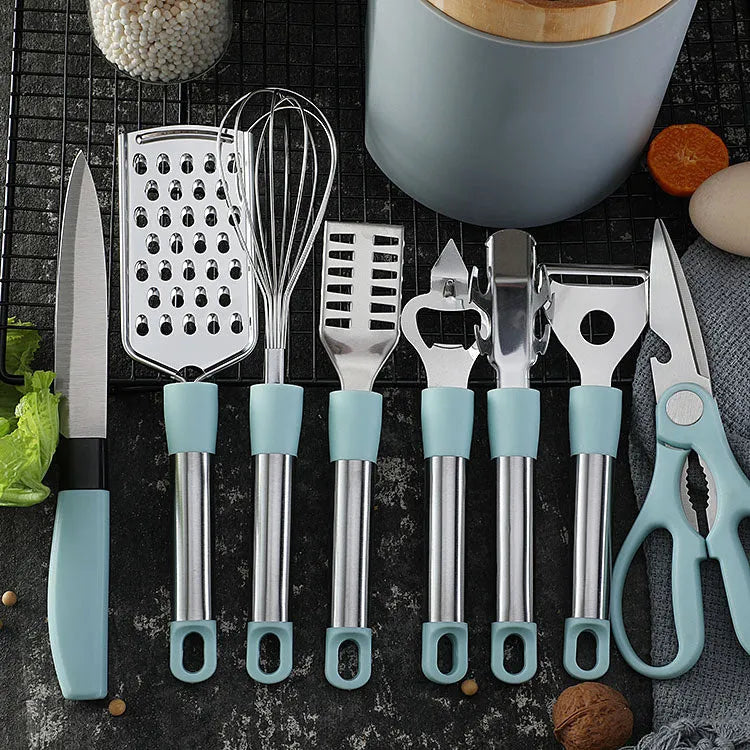 Stainless steel kitchen gadget set with whisk, grater, peeler, fruit knife, scissors, and tray lifter in grey