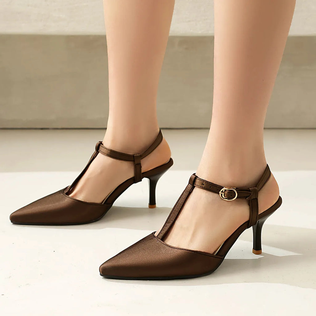 Women's pointed T-strap high heels in top grain leather, black colour, side view on plain background