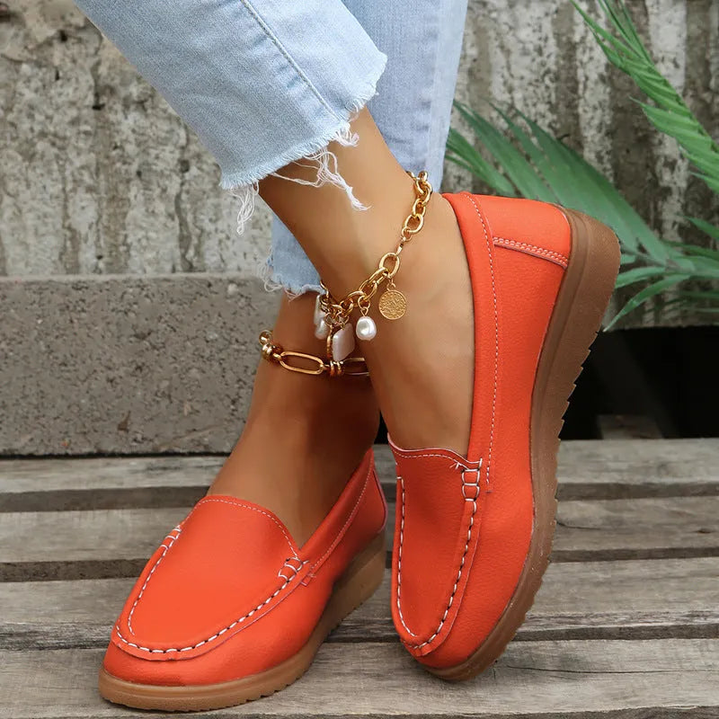 Women's black PU leather flat shoes with round toe and visible car suture stitching detail.