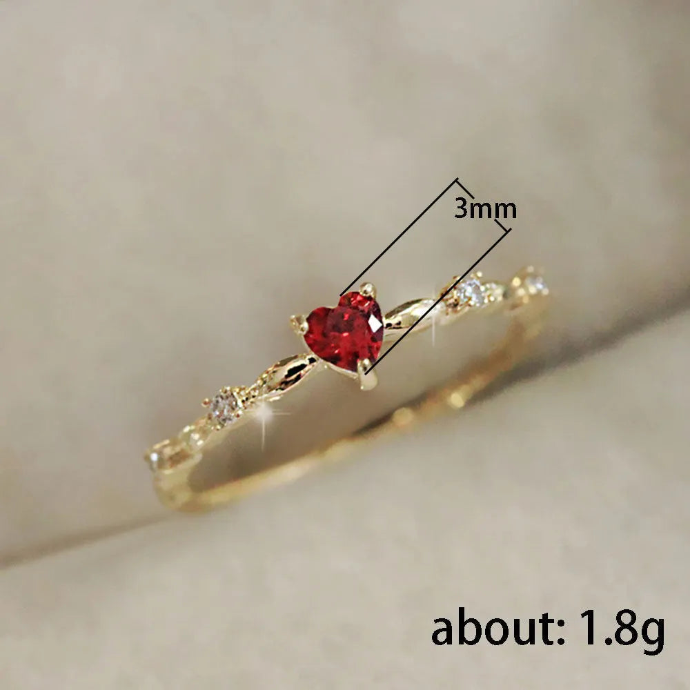 Gold and silver electroplated fashion ring with a peach heart charm and zircon stone.