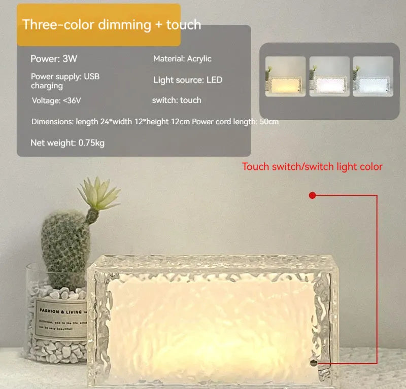 Small clear acrylic cube night light with colour-changing LED mood lighting on a wooden surface.
