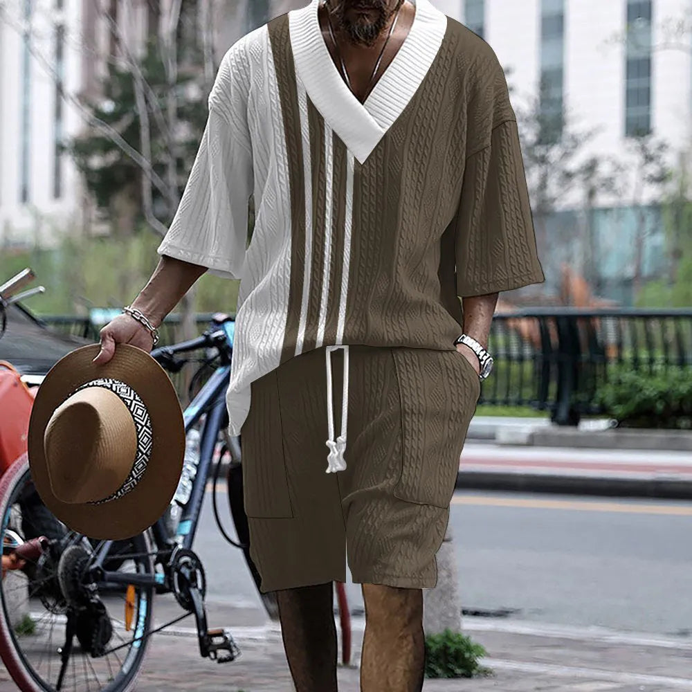Men's grey printed knitted short-sleeved top and matching shorts on a hanger.