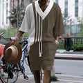 Men's grey printed knitted short-sleeved top and matching shorts on a hanger.