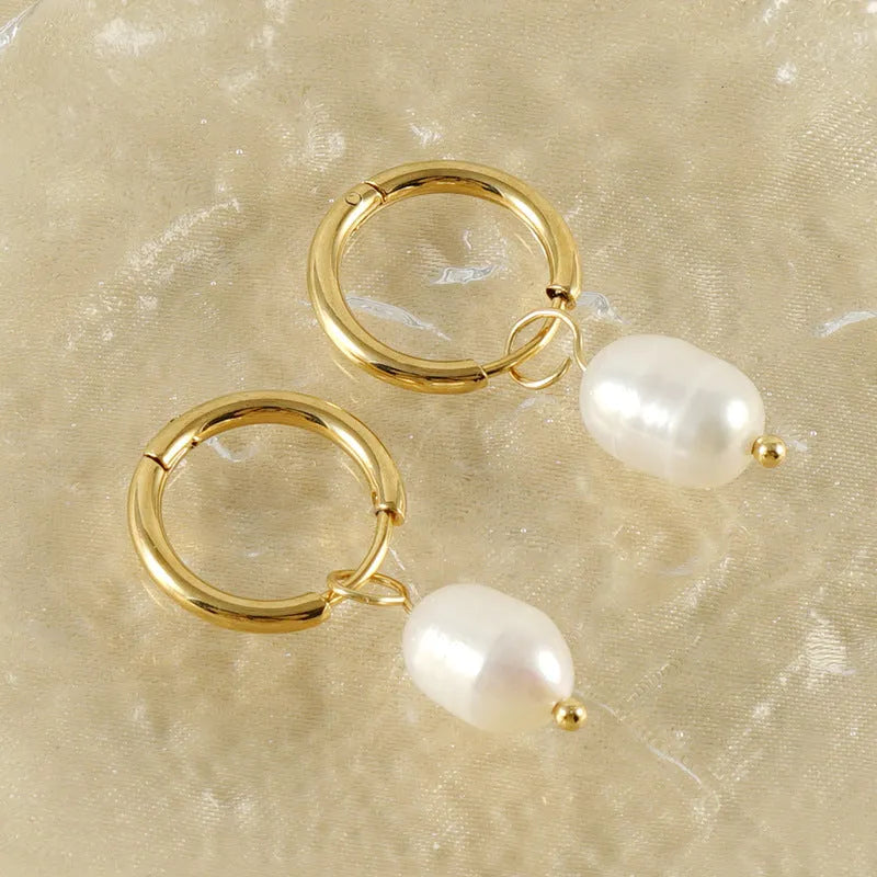 Gold geometric women's earrings made from stainless steel with a central pearl and titanium posts.
