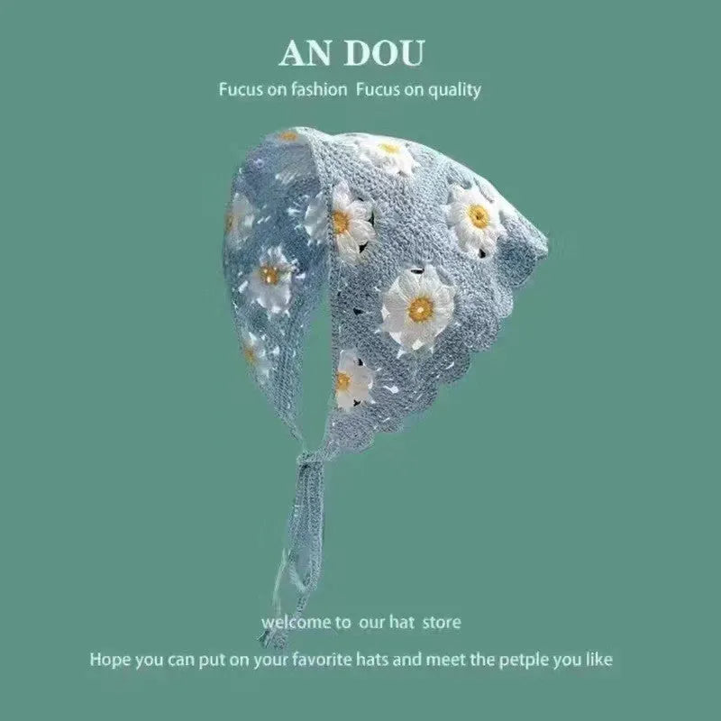 Cotton triangular headscarf with floral pattern spread flat showing its shape and design details.