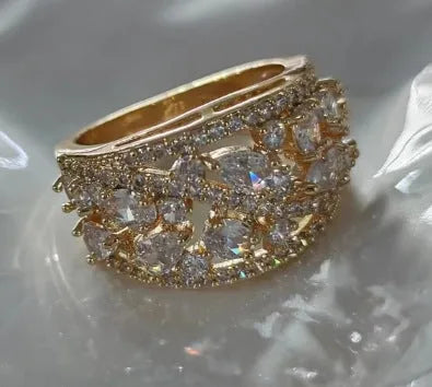 Women's round hollow fashion ring in copper with gold or platinum plating and blue or white accents