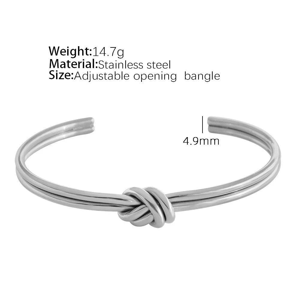 Women's stainless steel knotted C-shaped open double-layer bracelet in gold or silver tone.