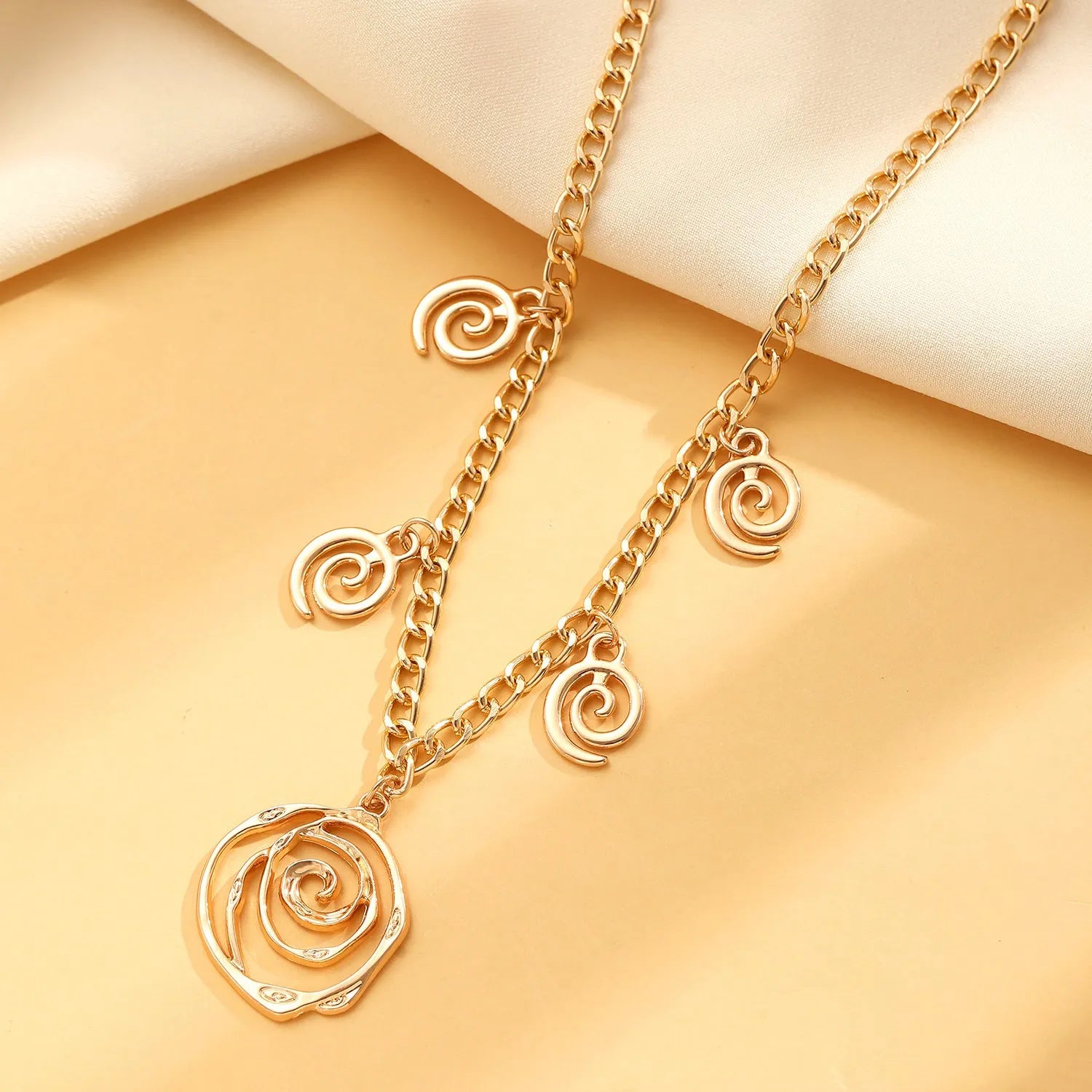 Geometric spiral donut jewellery set with necklace, bracelet, and earrings on adjustable 41-50cm chain