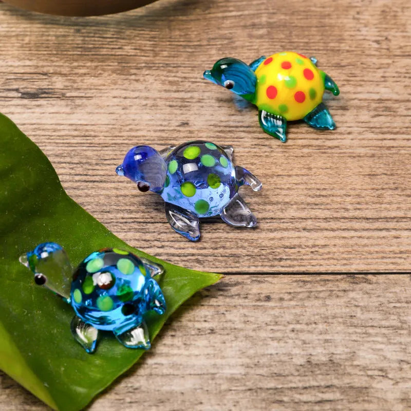 Geometric glass turtle sculpture ornament in a modern style on a wooden desktop.