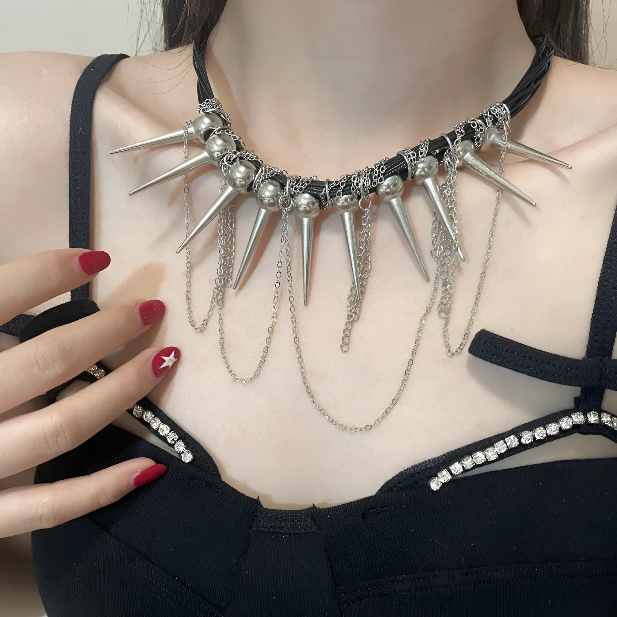 Women's casual leather necklace with a winding tassel, round beads, and silver rivet details.