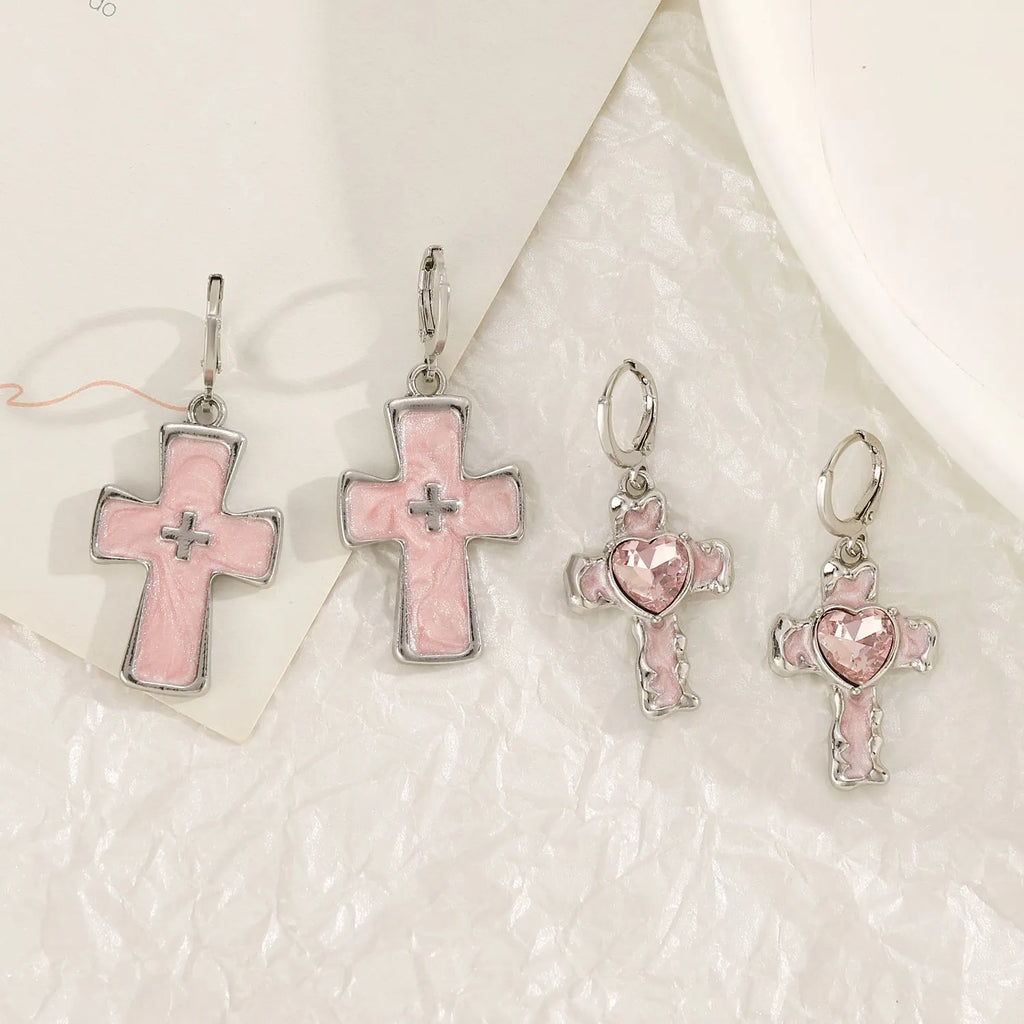 Women's alloy drop earrings featuring cross, heart, and cat charms in white, black, and antique silver finishes.