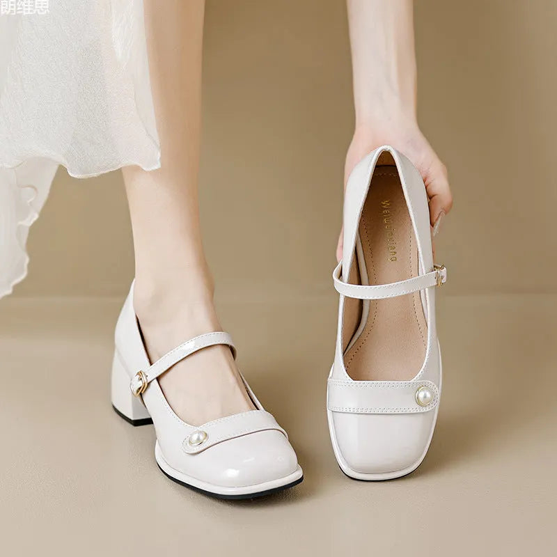 Plus size women's chunky heel pumps in patent leather with a square toe and front buckle, shown in apricot colour.