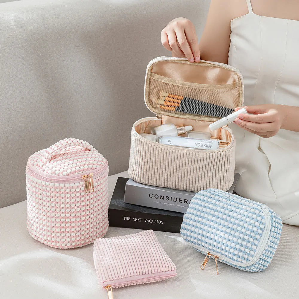 Four cube-style polyester makeup bags in coordinating colours