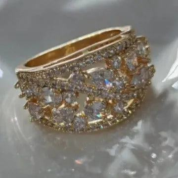 Women's round hollow fashion ring in copper with gold or platinum plating and blue or white accents