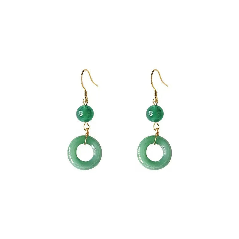Green geometric peace buckle shape earrings with jade design on zinc alloy background
