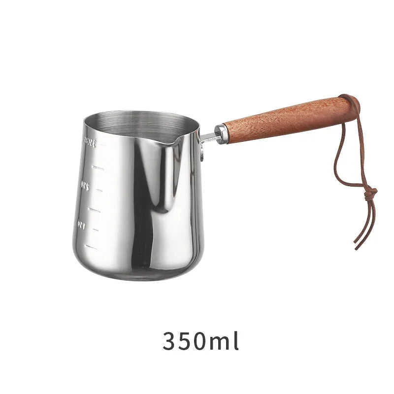 Garland stainless steel coffee milk jug with wooden handle, showing interior volume scale markings.
