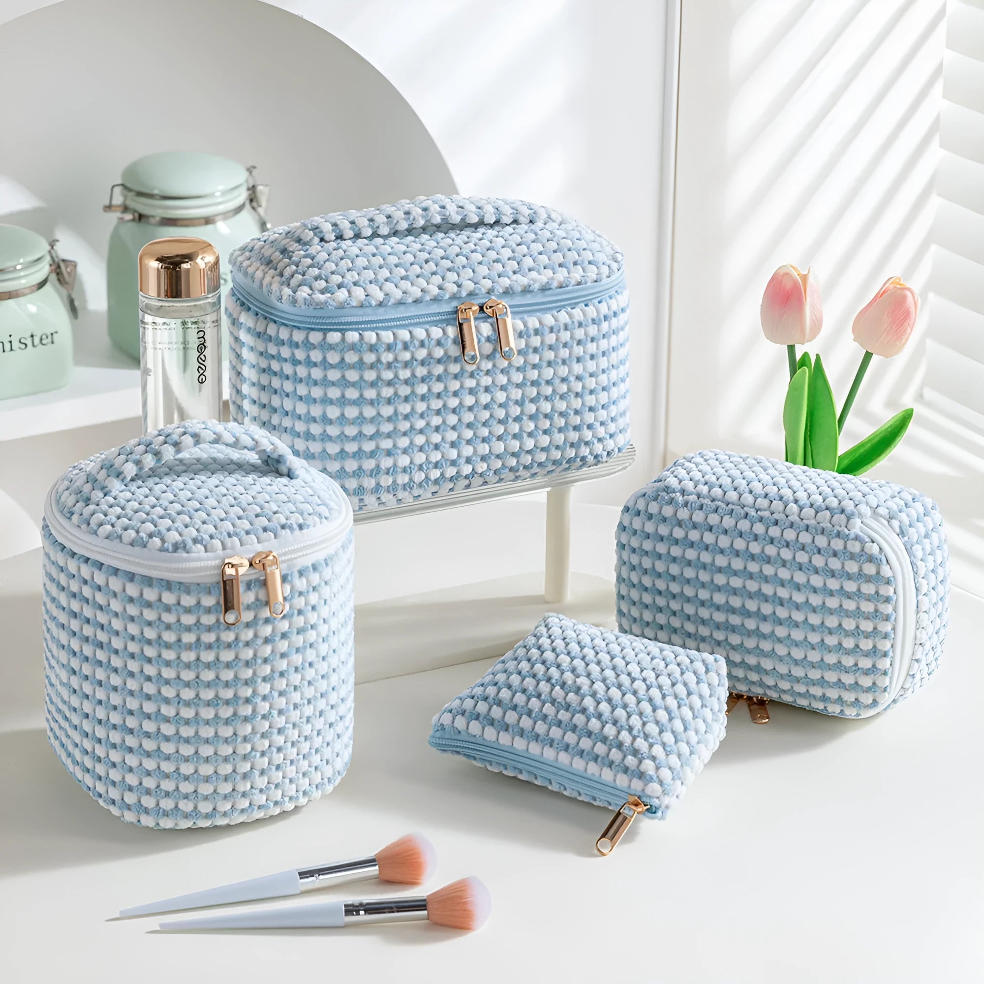 Four cube-style polyester makeup bags in coordinating colours