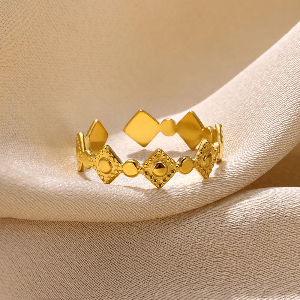 Golden diamond geometric titanium steel women's ring on display