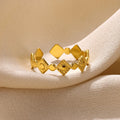 Golden diamond geometric titanium steel women's ring on display
