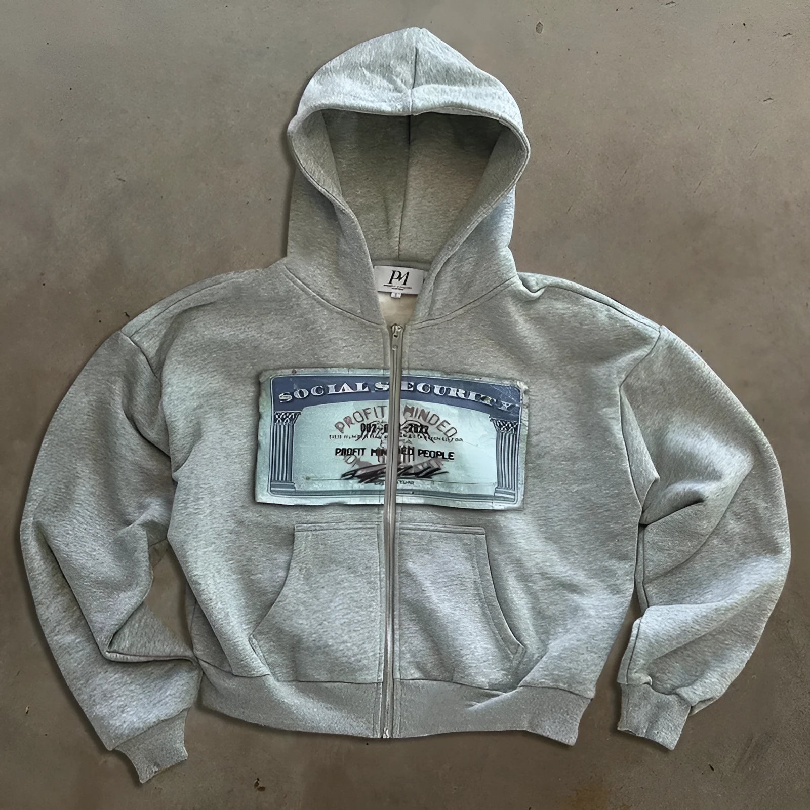 Black loose fit zip-up hoodie jacket with a letter pattern and zipper pockets for men and women.