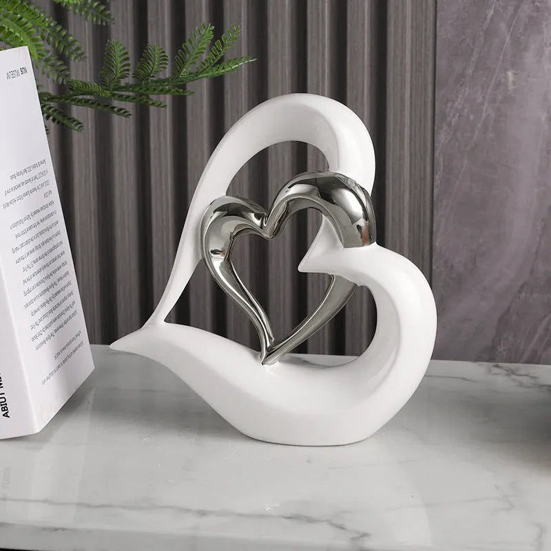 Modern geometric love heart ornament in white porcelain with metallic finish on display surface