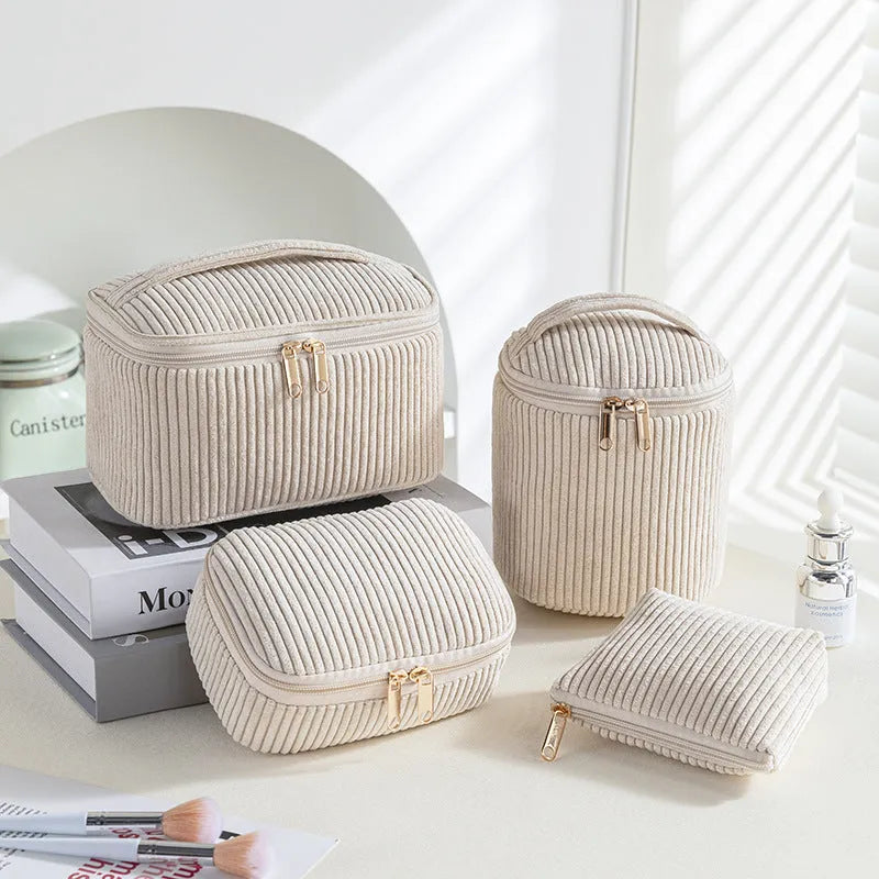 Four cube-style polyester makeup bags in coordinating colours