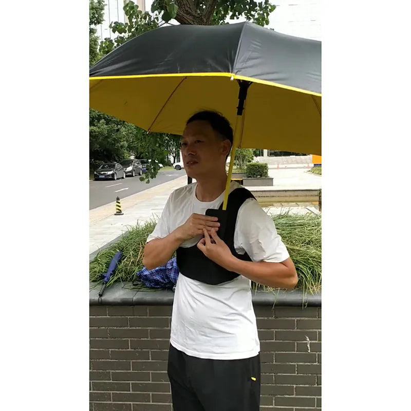 Black portable umbrella holder with a shoulder strap for beach sunshades, shown next to a manual umbrella