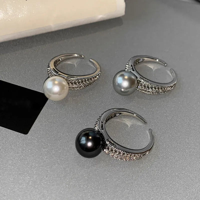 Adjustable black pearl copper ring with geometric open design for women