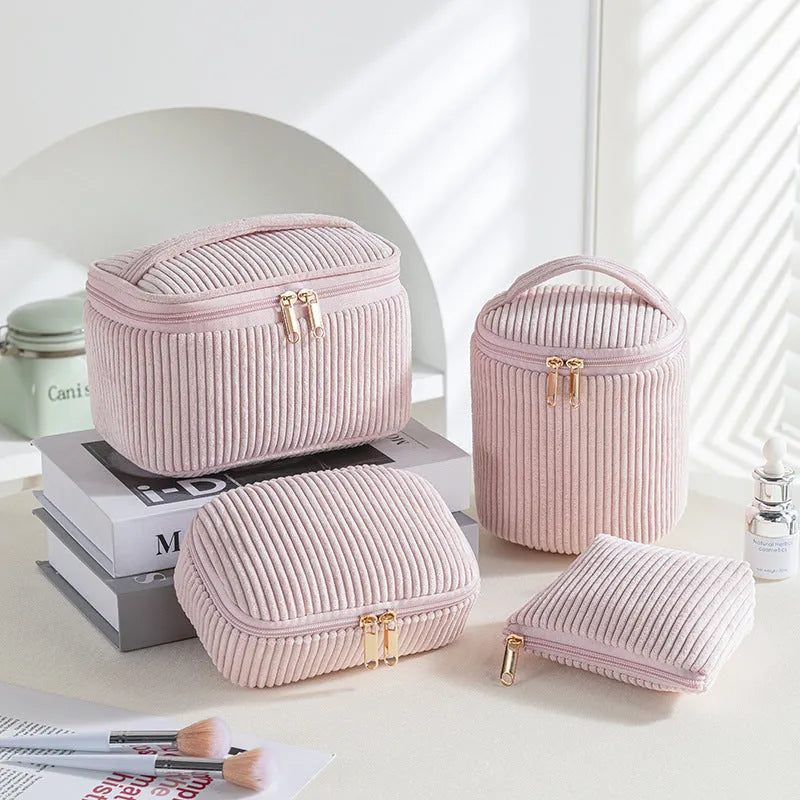 Four cube-style polyester makeup bags in coordinating colours