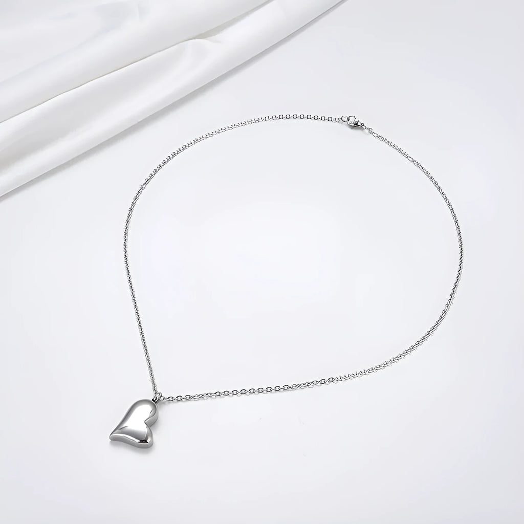 Silver curved peach heart pendant necklace on adjustable stainless steel chain