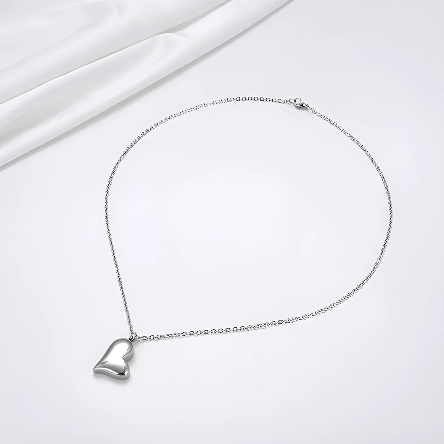 Silver curved peach heart pendant necklace on adjustable stainless steel chain