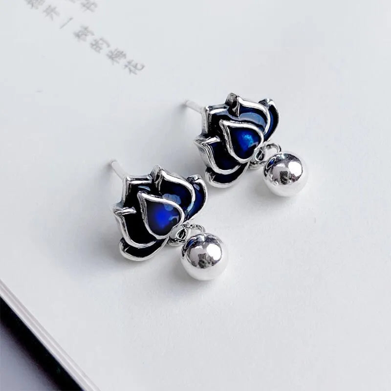 A pair of blue lotus flower alloy ear studs with a retro tassel design.