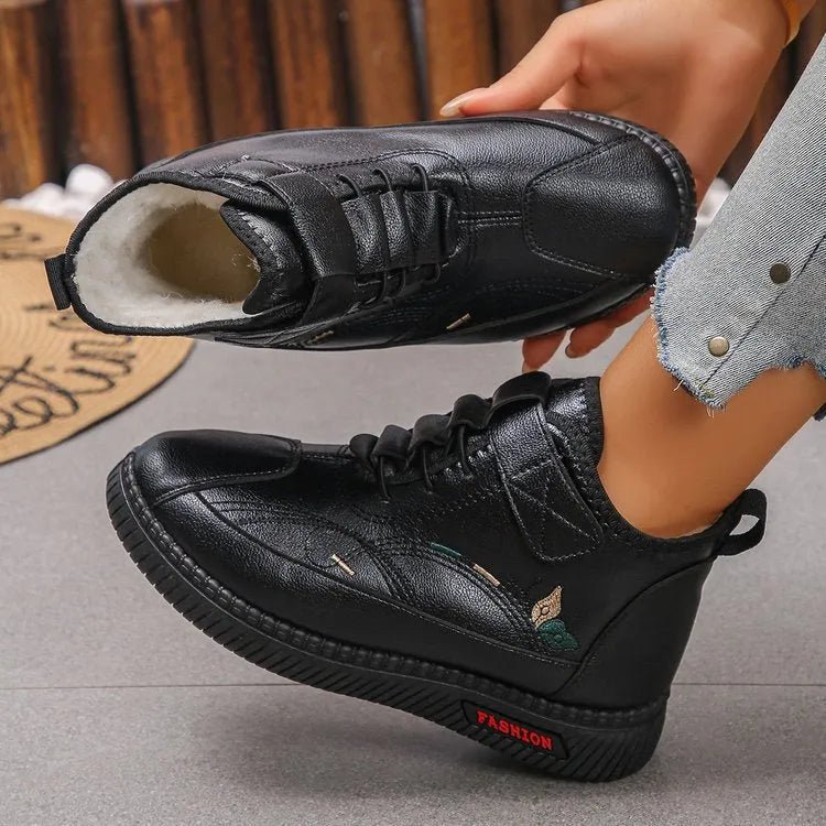 Women's black velvet indoor slip-on shoes with a rubber sole and decorative hollow-out detail