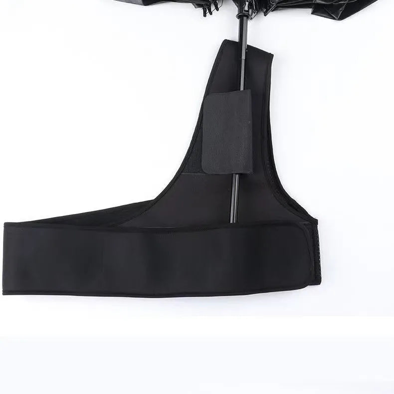 Black portable umbrella holder with a shoulder strap for beach sunshades, shown next to a manual umbrella