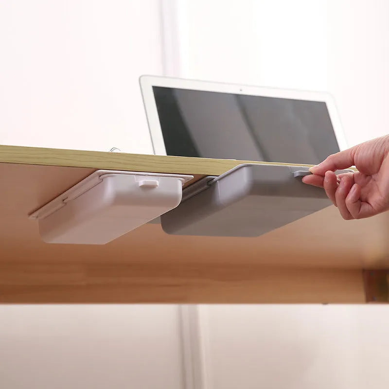 Plastic storage box with adhesive base for mounting under a table