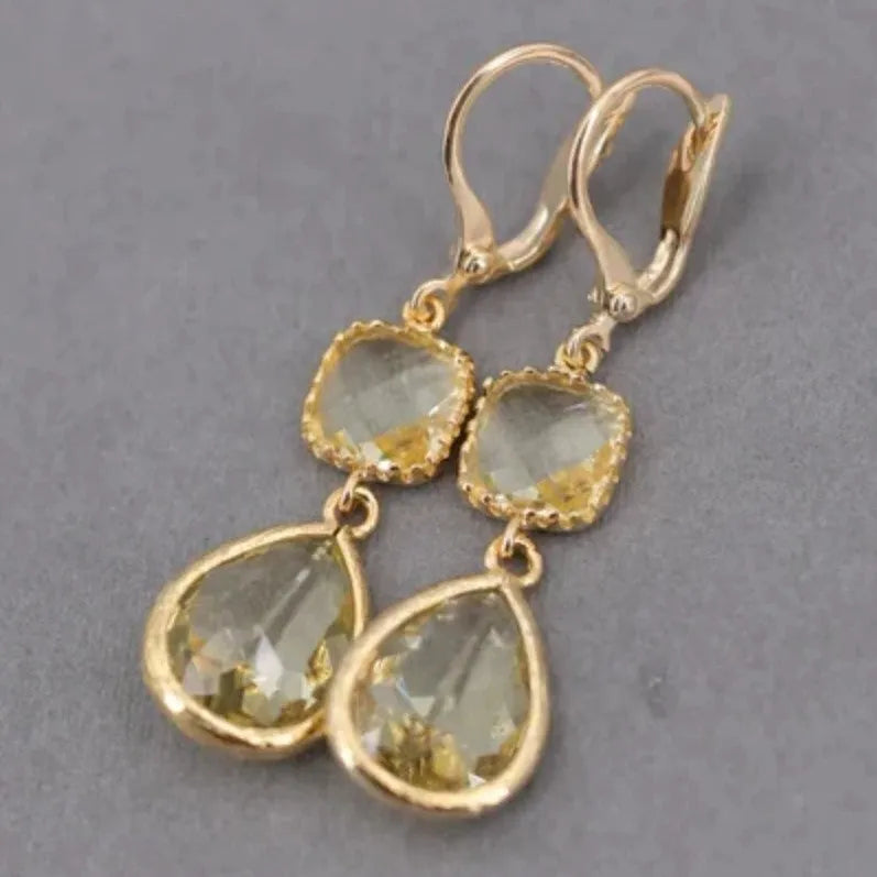 Gold retro geometric earrings with long crystal fringe and water droplet design.