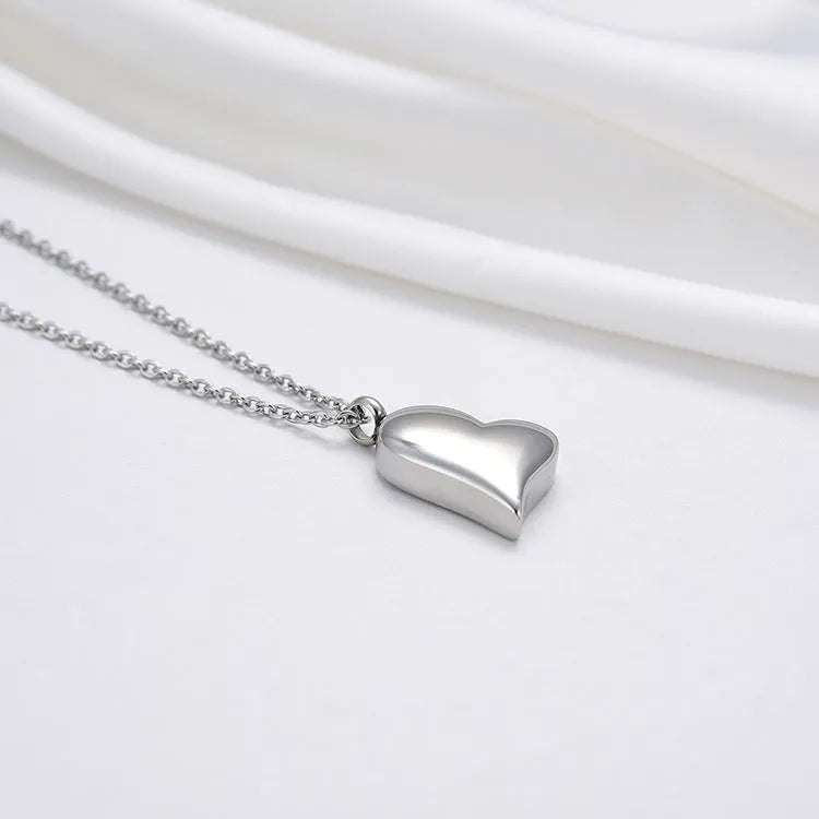 Silver curved peach heart pendant necklace on adjustable stainless steel chain
