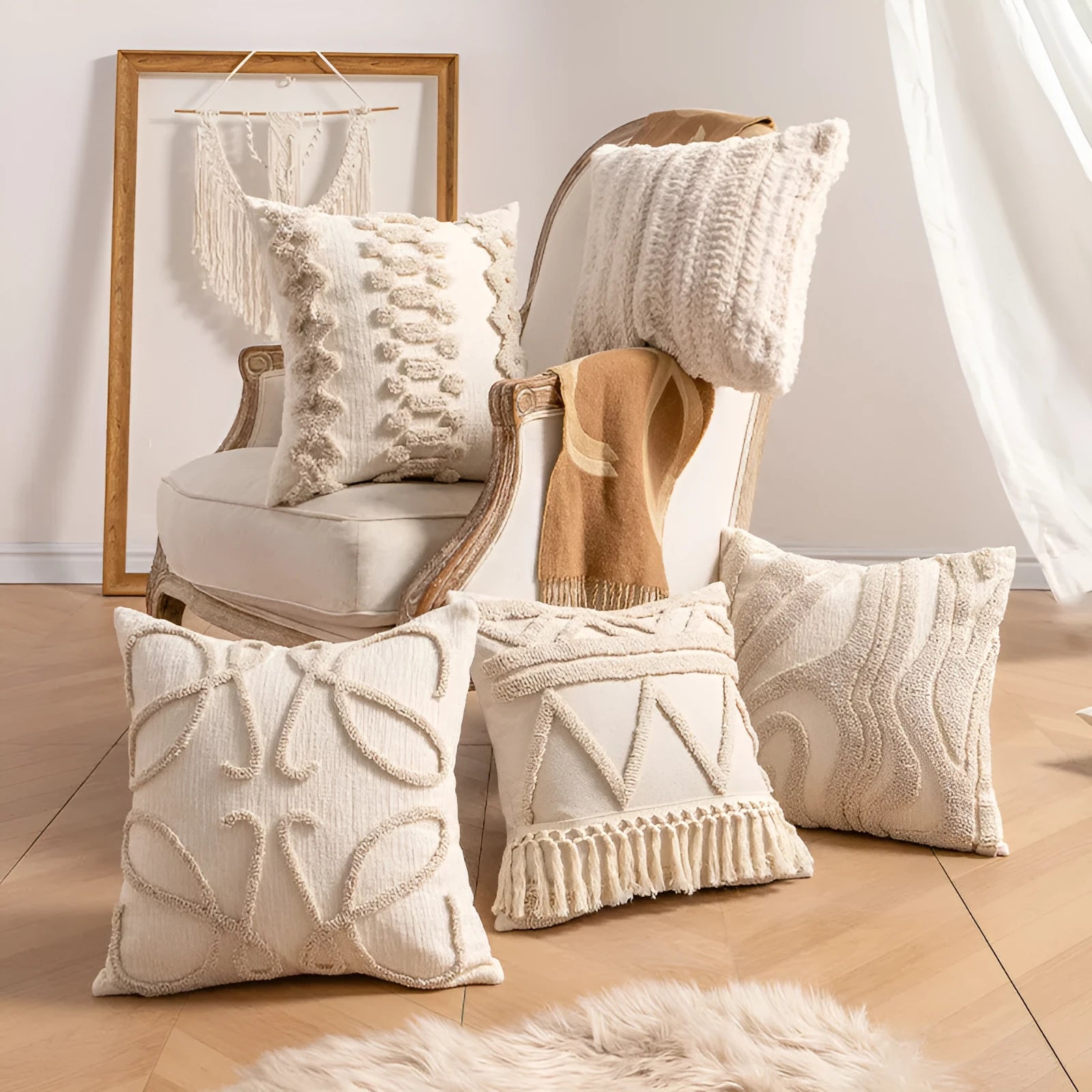 Knitted cushion cover with tassel fringe in a patterned design, shown on a sofa.