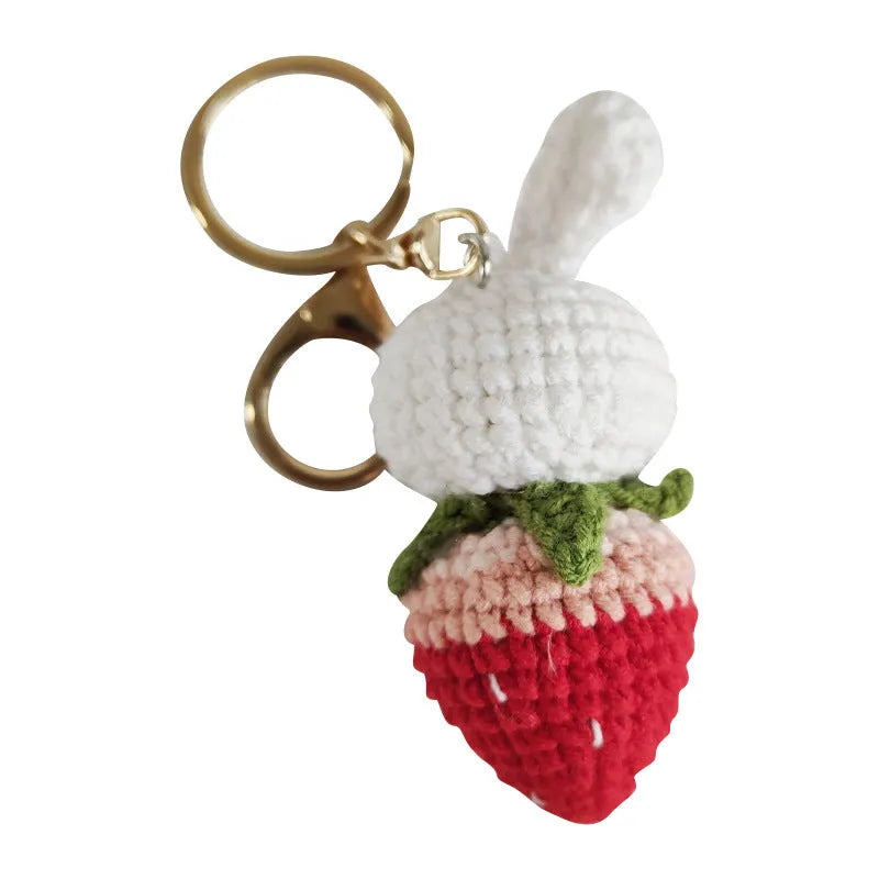 Hand-woven white wire pendant with rabbit and strawberry cartoon design and attached key