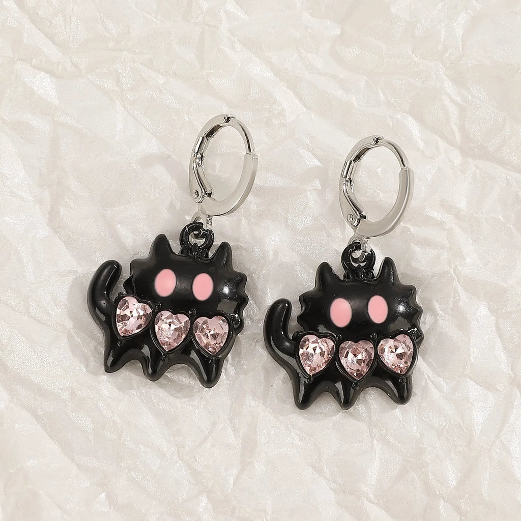 Women's alloy drop earrings featuring cross, heart, and cat charms in white, black, and antique silver finishes.