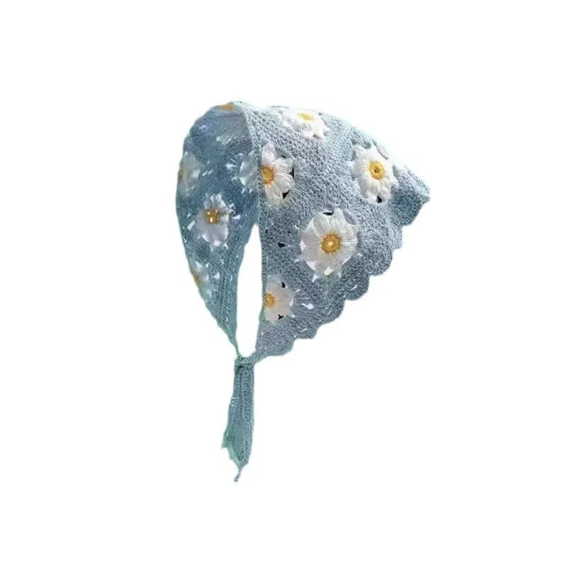 Cotton triangular headscarf with floral pattern spread flat showing its shape and design details.