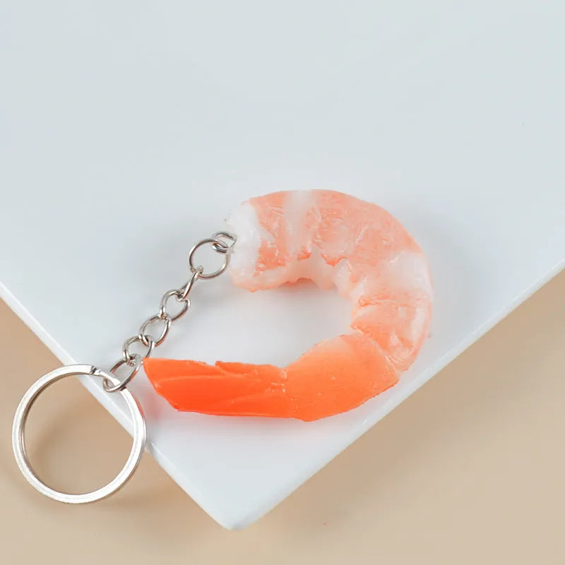 Detailed PVC simulation shrimp keychain bag charm on a white background.