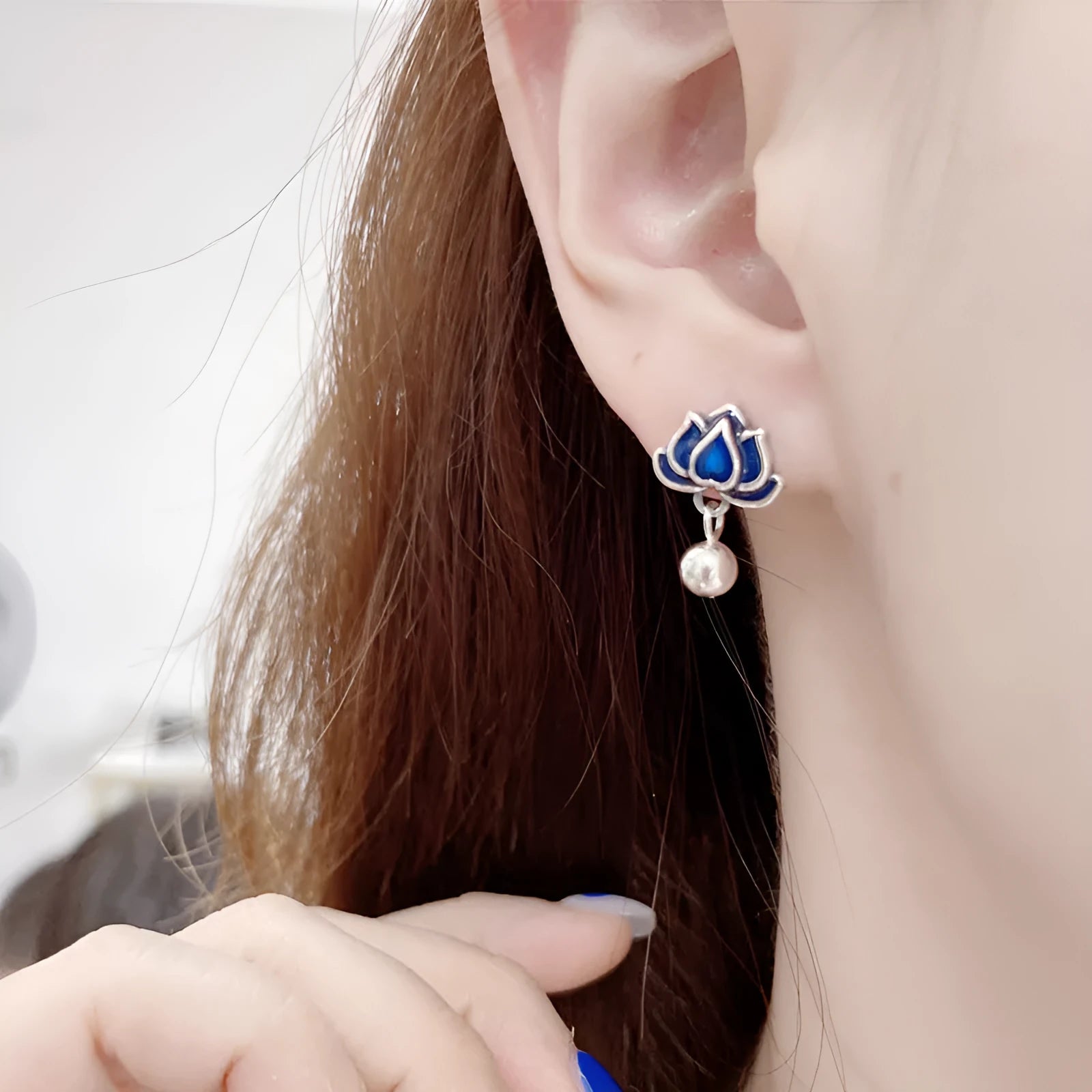 A pair of blue lotus flower alloy ear studs with a retro tassel design.