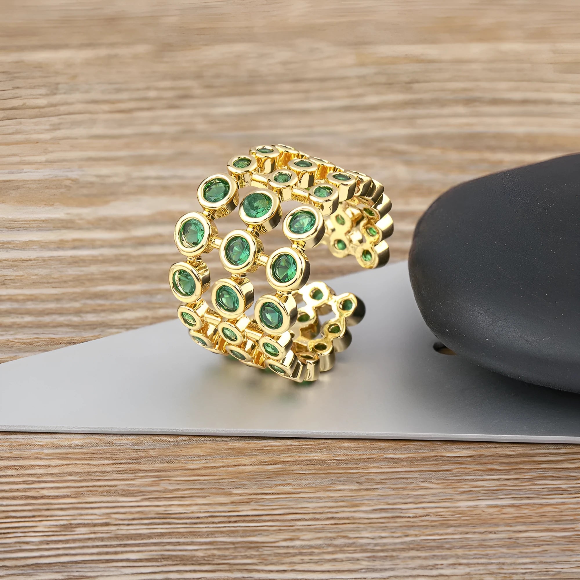 Gold coloured wide band ring with green zircon stones and three-layer copper plating
