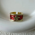 Adjustable copper drop oil ring with a distressed XINGX design in geometric shape.