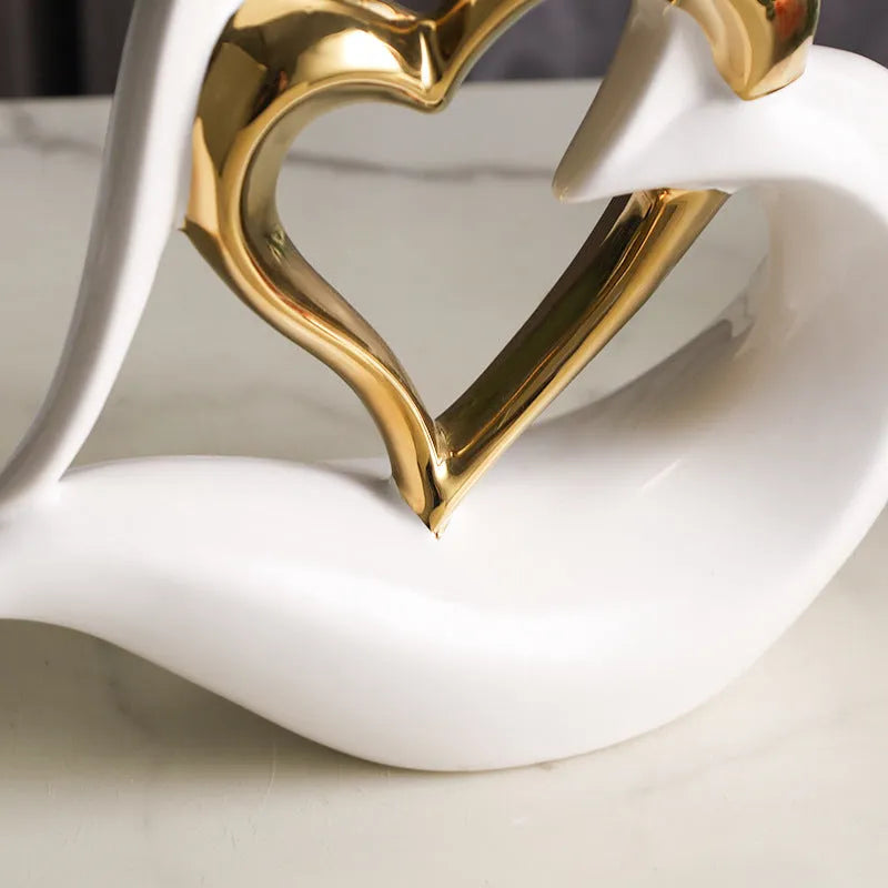 Modern geometric love heart ornament in white porcelain with metallic finish on display surface