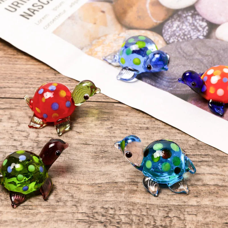 Geometric glass turtle sculpture ornament in a modern style on a wooden desktop.