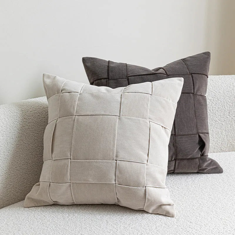 Square chenille woven cushion in beige colour on a grey sofa, 50x50cm size.