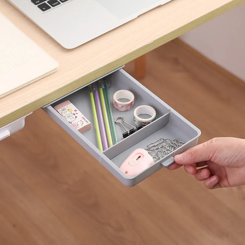 Plastic storage box with adhesive base for mounting under a table