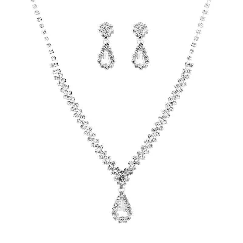 Rhinestone drop pendant necklace and matching earrings with geometric claw chain, shown in blue.